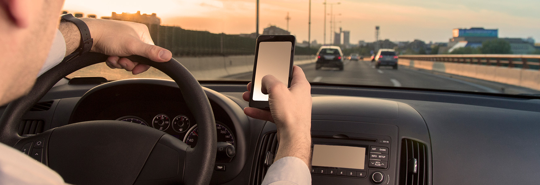 Man driving while reading text