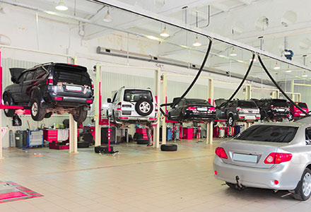Garage with a line of cars on lifts