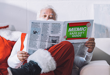 Santa Claus reading MEMIC Safe Gift Guide