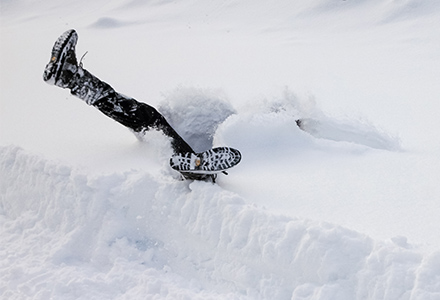 Person in snowbank with boots sticking up