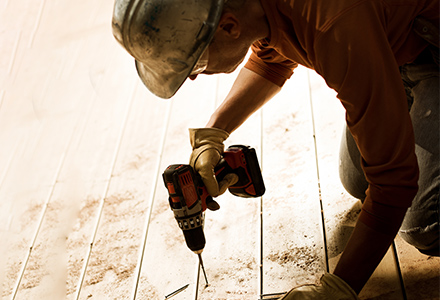 Worker using power drill