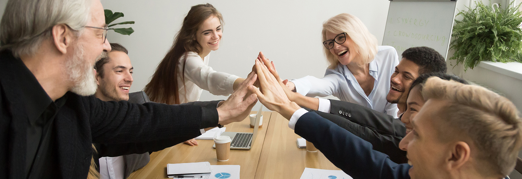 group of co-workers high-fiving