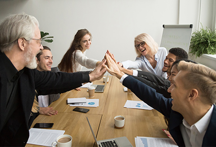 group of co-workers high-fiving