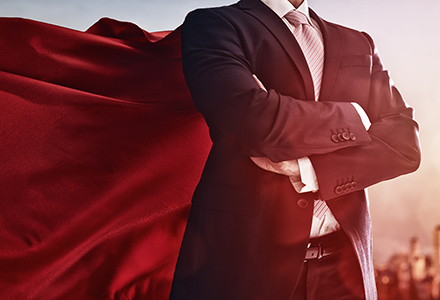 Man in suit with superman cape