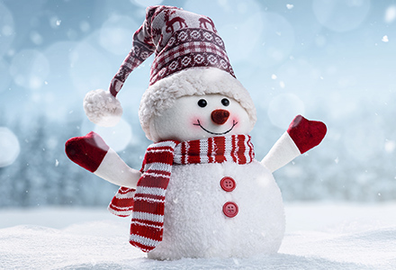 Happy snowman with hat, scarf, and gloves standing in a snowy field