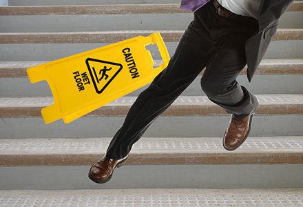A man slipping and falling down the stairs.