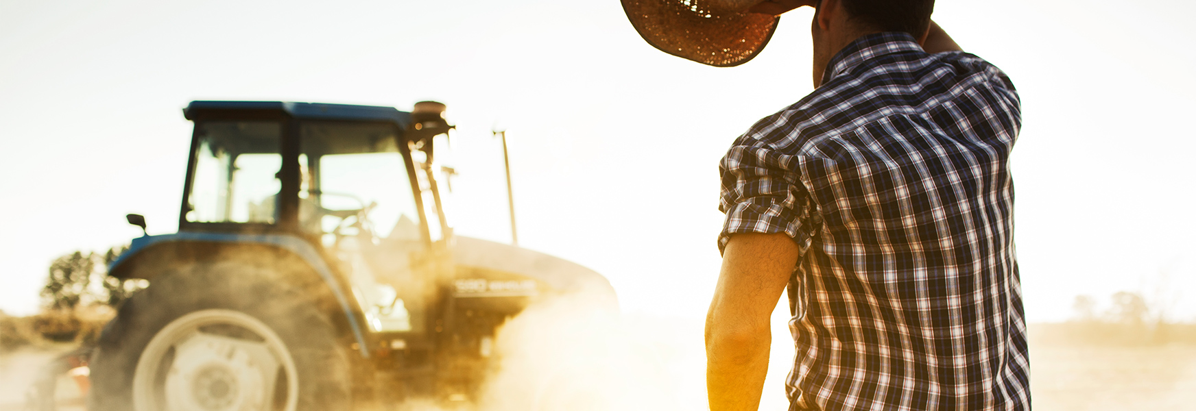 Man with tractor working in the hot sun