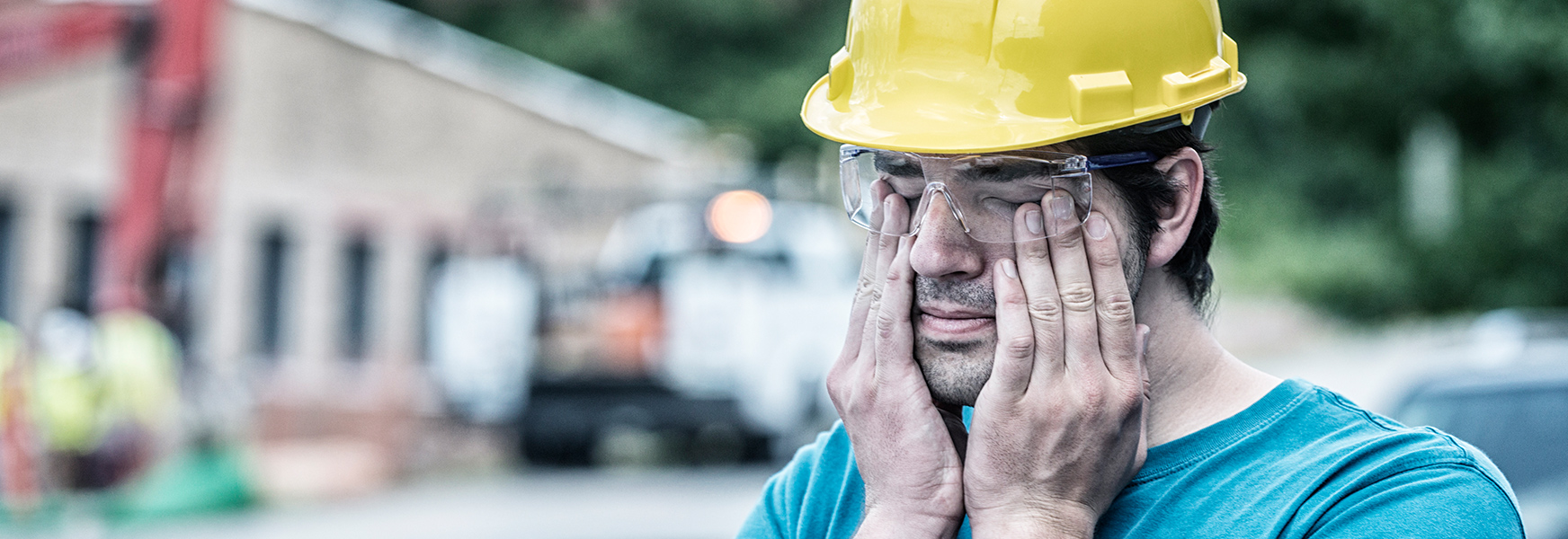 Drowsy Construction Worker Rubs Eyes