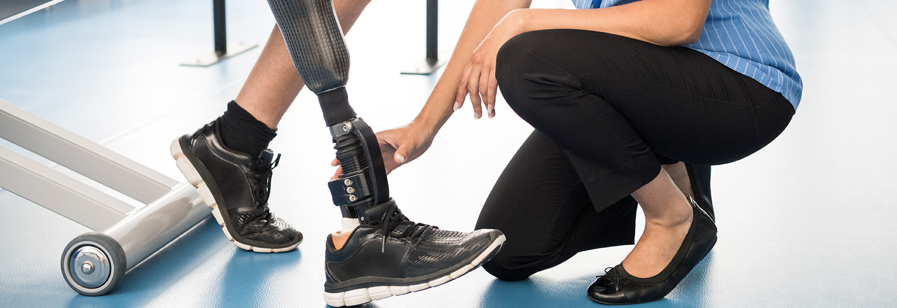 Medical professional assists patient with prosthetic leg