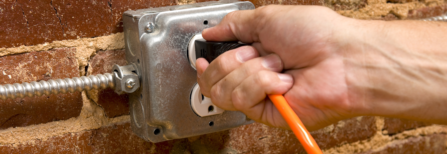 Hang plugging extension cord into outlet