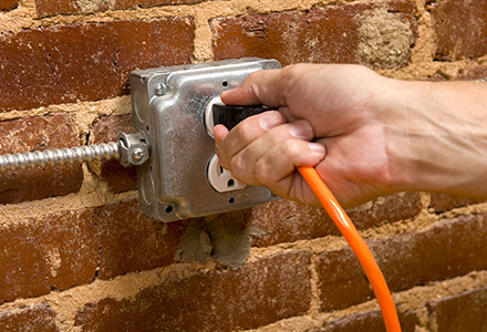 Hang plugging extension cord into outlet