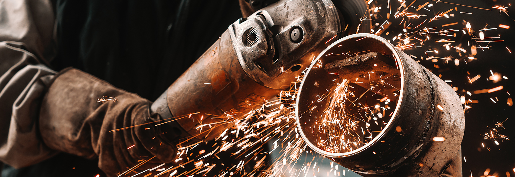 Gloved worker using cutting tool