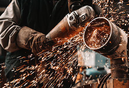 Gloved worker using cutting tool