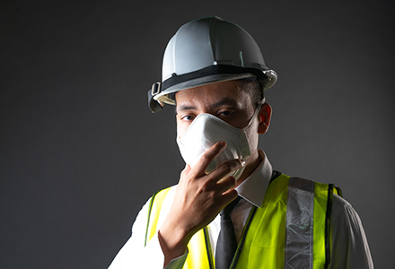 Male construction worker wearing a face mask