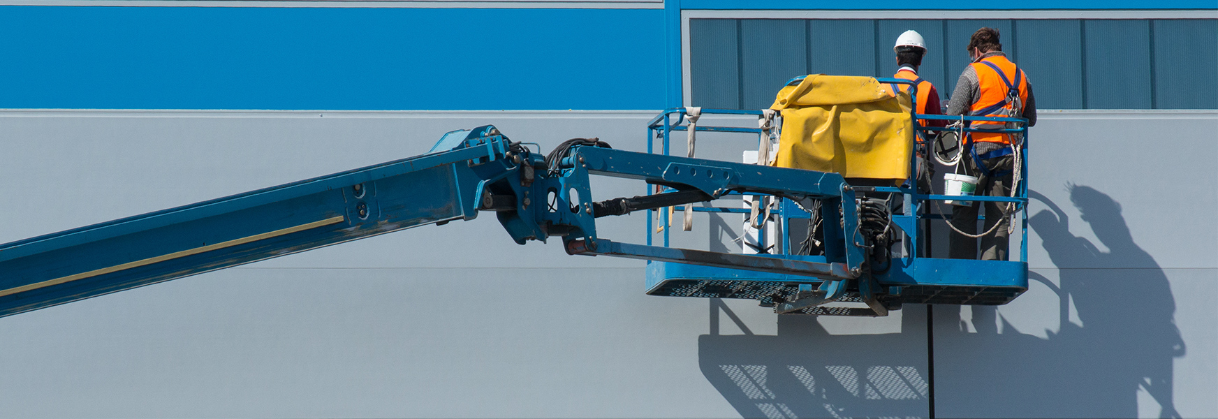 Two workers working in a boom lift.