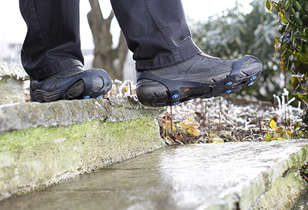 Boots equipped with traction enhancers.