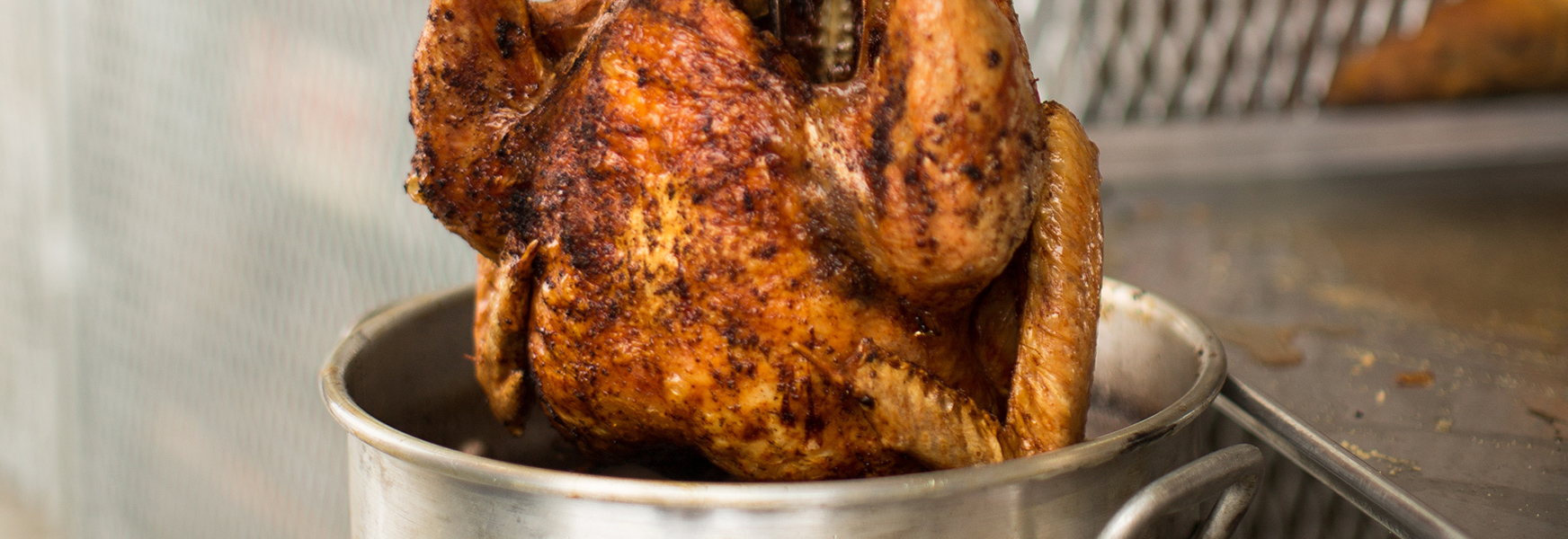 Deep fried turkey being removed from fryer.