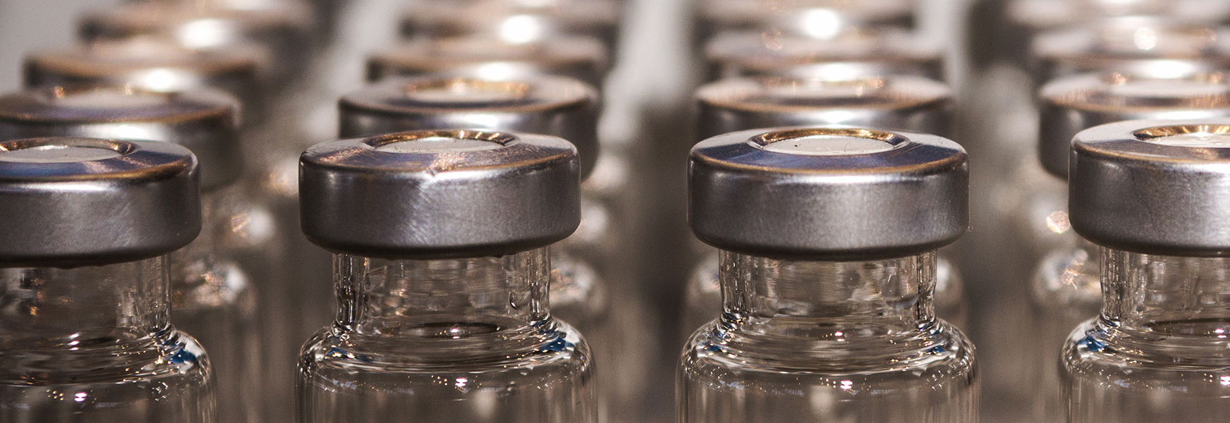 Empty vaccine bottles exiting production line
