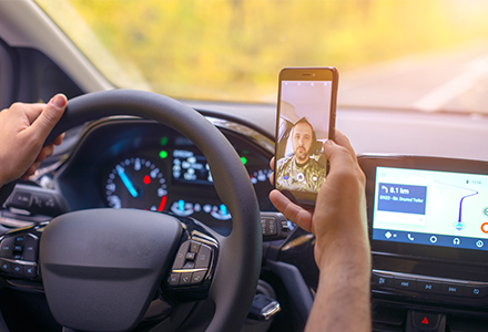 Distracted driver using cellphone to pictures of himself