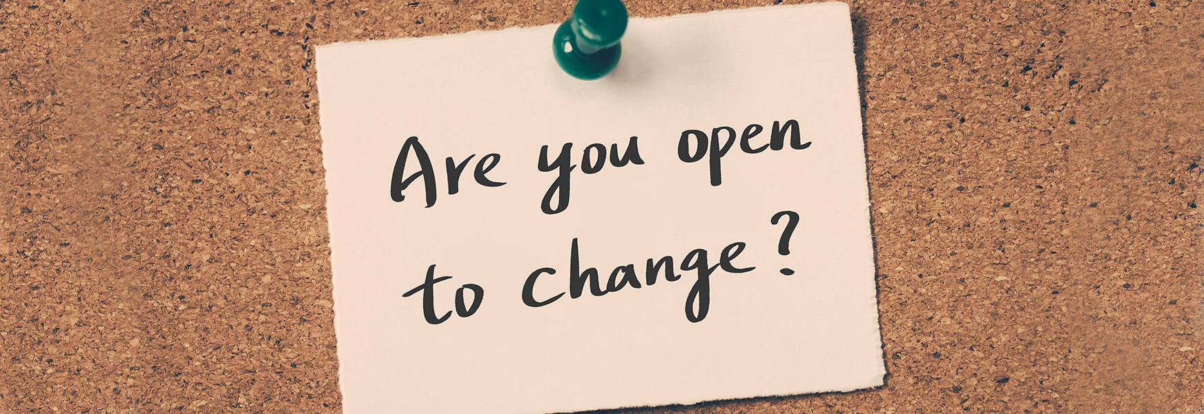 "Are you open to change?" sticky note pinned to corkboard.