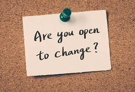 "Are you open to change?" sticky note pinned to corkboard.