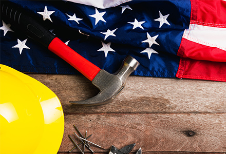 Hardhat and tools on American flag