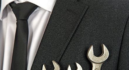 Wrenches in businessman's suit jacket pocket
