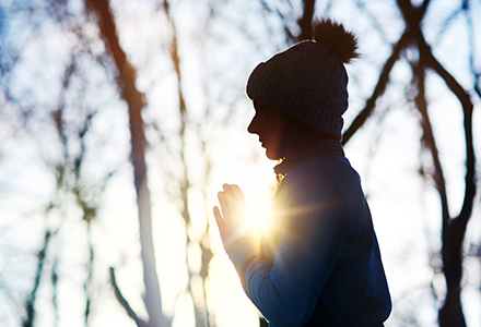 Young woman meditating outside during winter