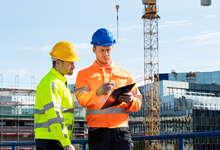 Construction workers assessing site