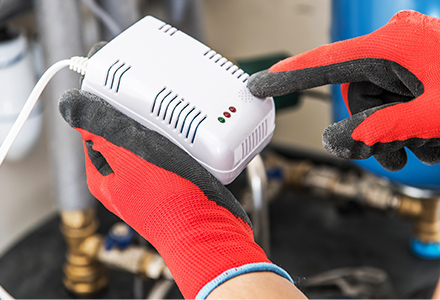 Technician Installing Carbon Monoxide Detector