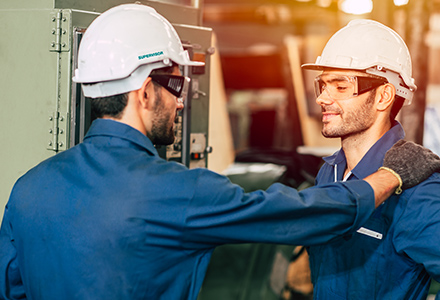 Supervisor praising worker in factory