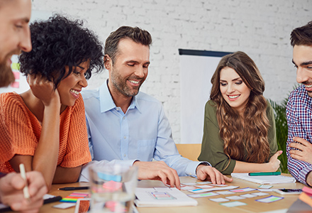 Happy young professionals in training classroom