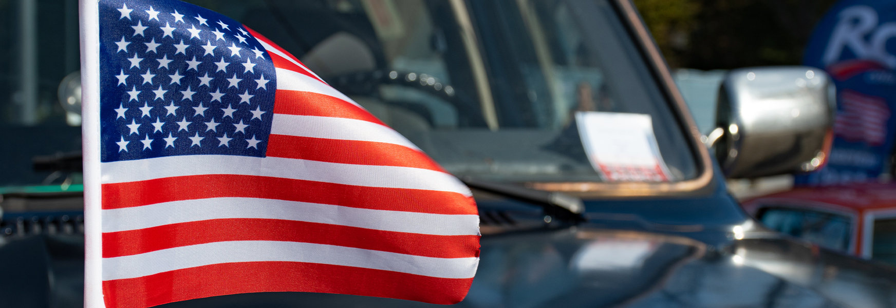 American flag on hood of pickup truck
