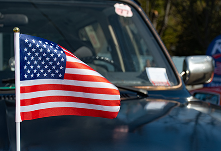 American flag on hood of pickup truck