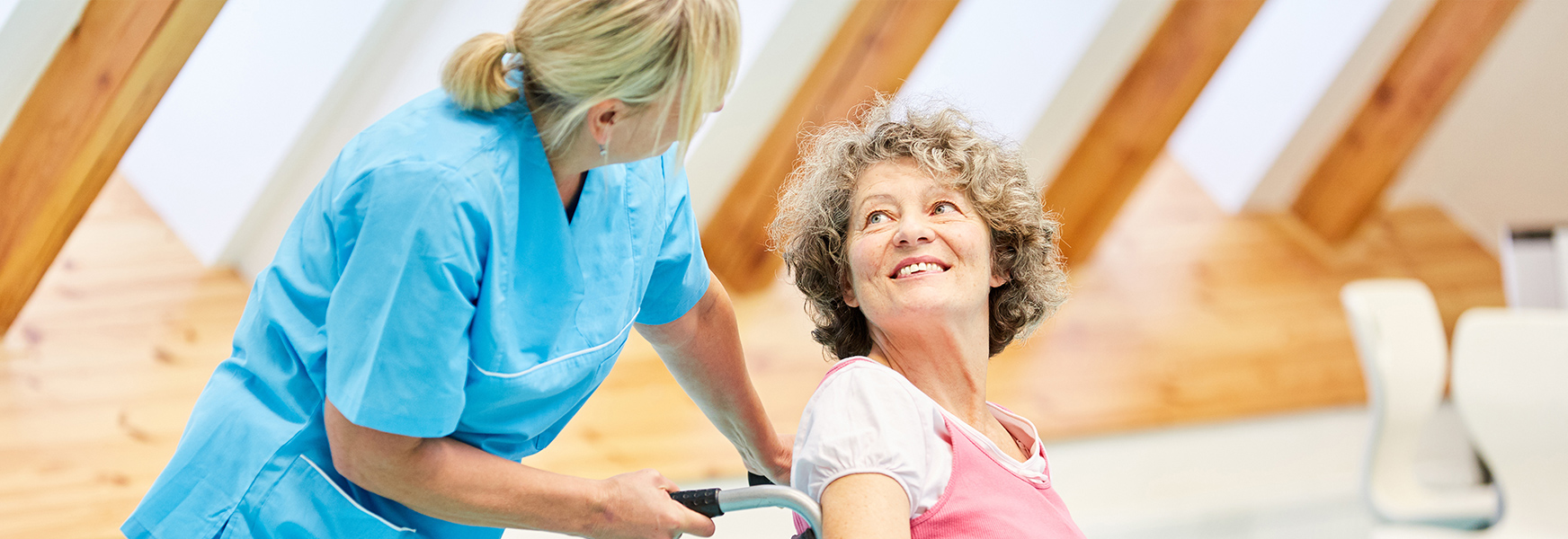 Nurse assisting patient in wheelchair