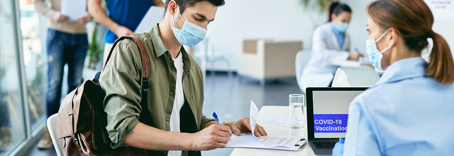 Man doing paperwork before COVID-19 vaccination