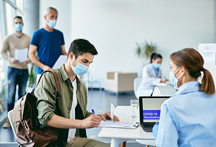 Man doing paperwork before COVID-19 vaccination