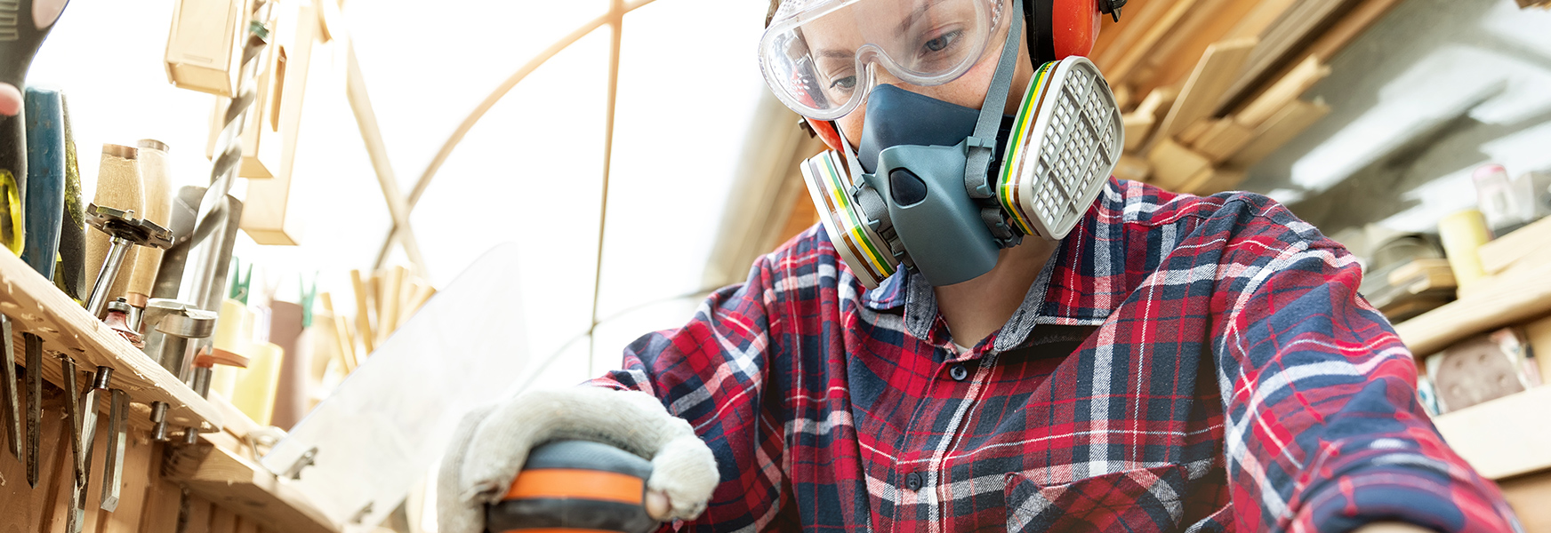 Young woman wearing PPE while working on DIY project at home