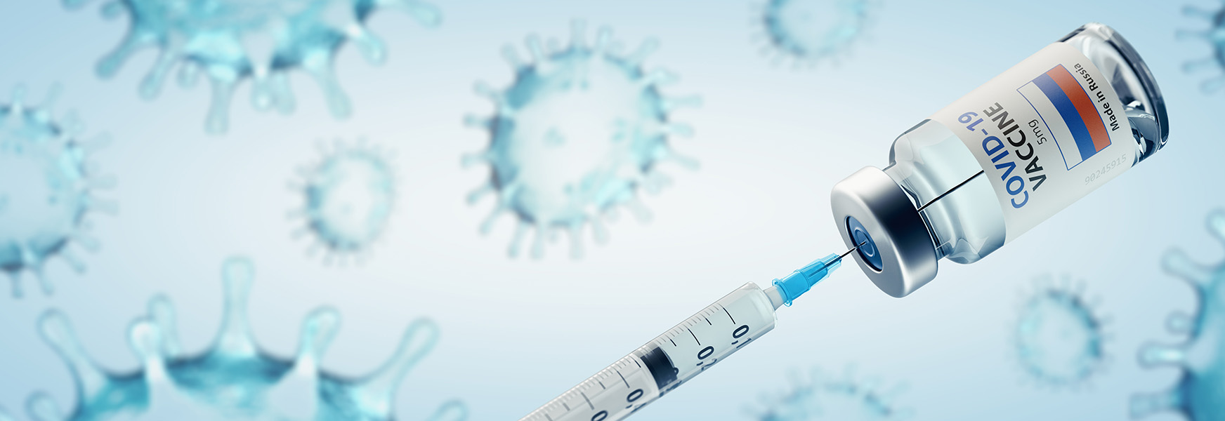 Syringe inserted into Covid19 vaccine bottle.
