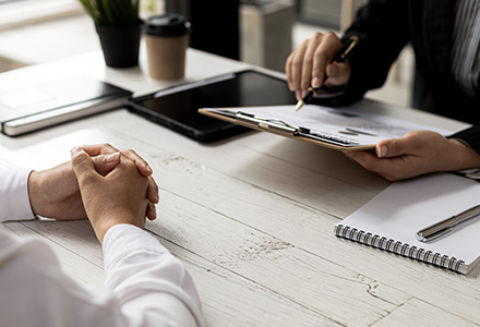 Hiring team reviewing documents with new-hire.