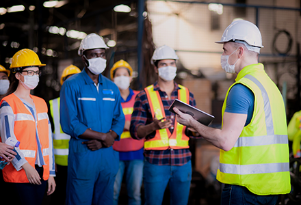 Factory workers having a daily safety meeting