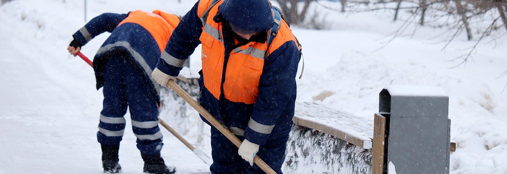 Workers shoveling snow in winter