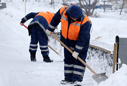 Workers shoveling snow in winter