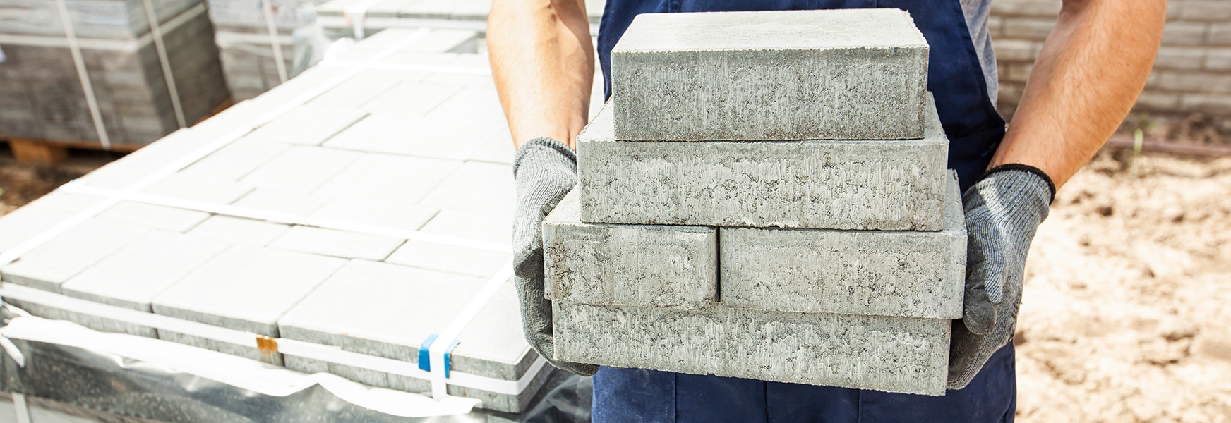 Stone worker carrying stone blocks