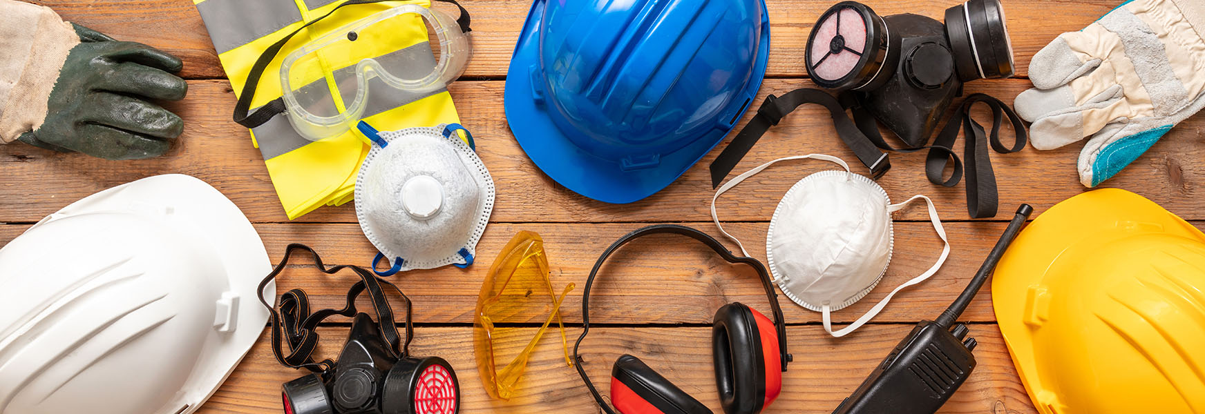 Assorted PPE on a wooden table