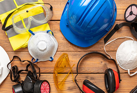 Assorted PPE on a wooden table