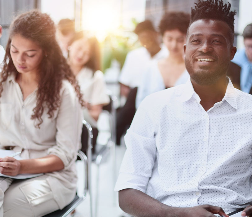 Multicultural audience in a modern conference room