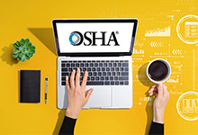 Open laptop with OSHA logo visible on screen