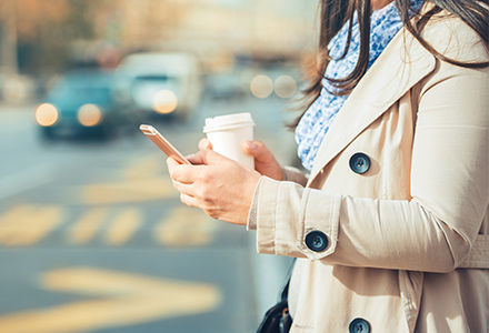 Woman on cell phone near traffic