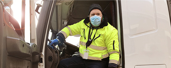 Delivery driver wearing masks and gloves in a box truck